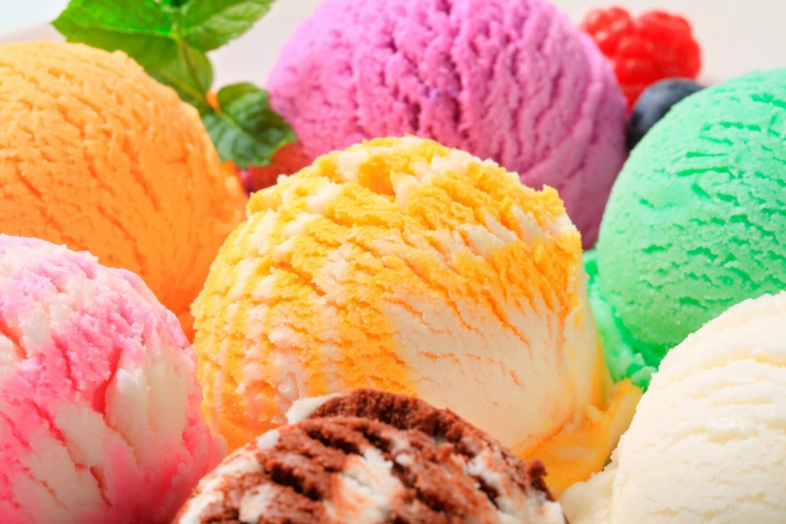 A close up of different flavors of ice cream.